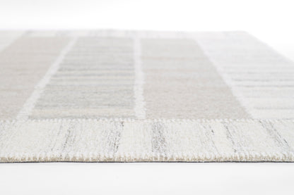 Light gray & beige patchwork area rug with a soft textured pile; rectangular block design.