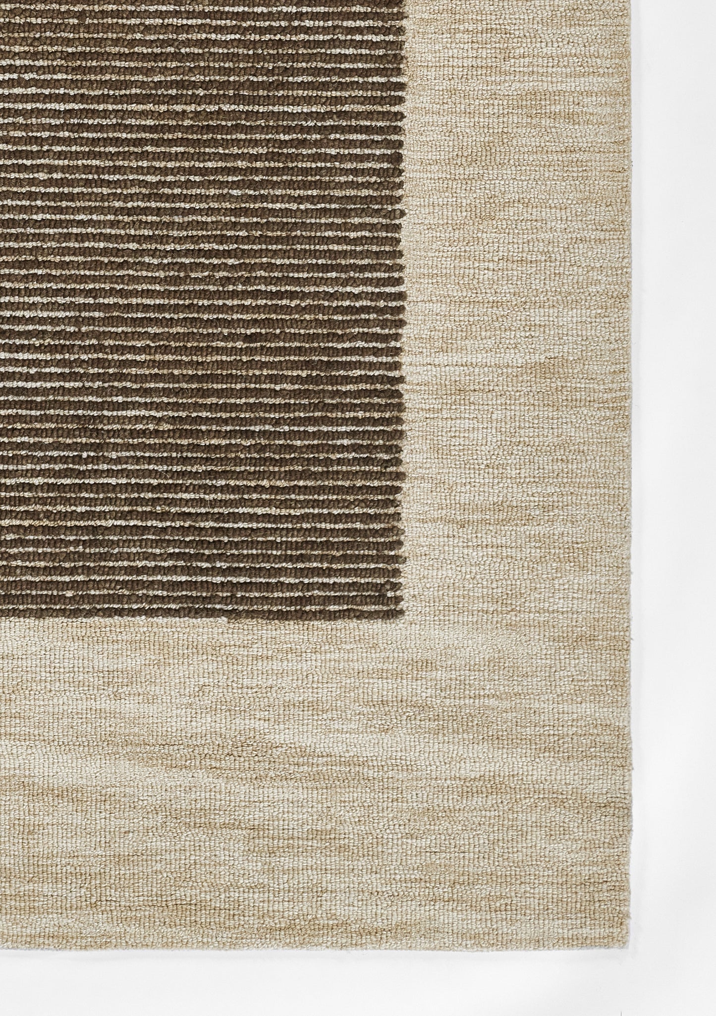 Rectangular area rug with dark brown ribbed center panel and a wide beige border; plush looped texture.