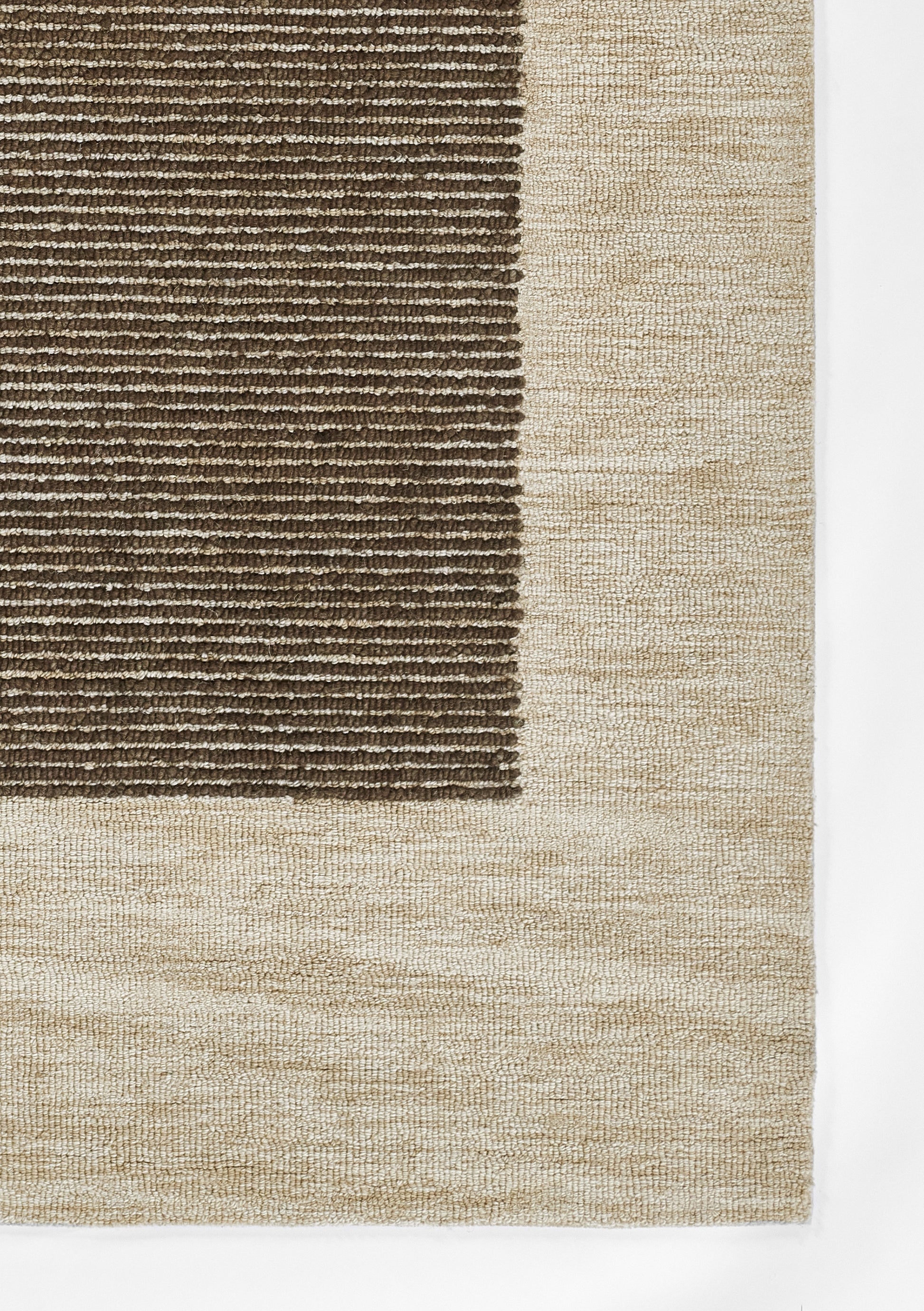 Rectangular area rug with dark brown ribbed center panel and a wide beige border; plush looped texture.