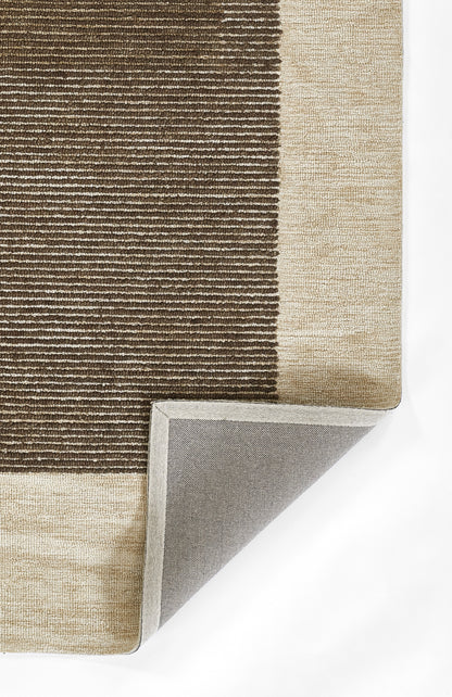 Rectangular area rug with brown and beige striped pattern, woven texture, light beige border, folded corner shows gray backing.