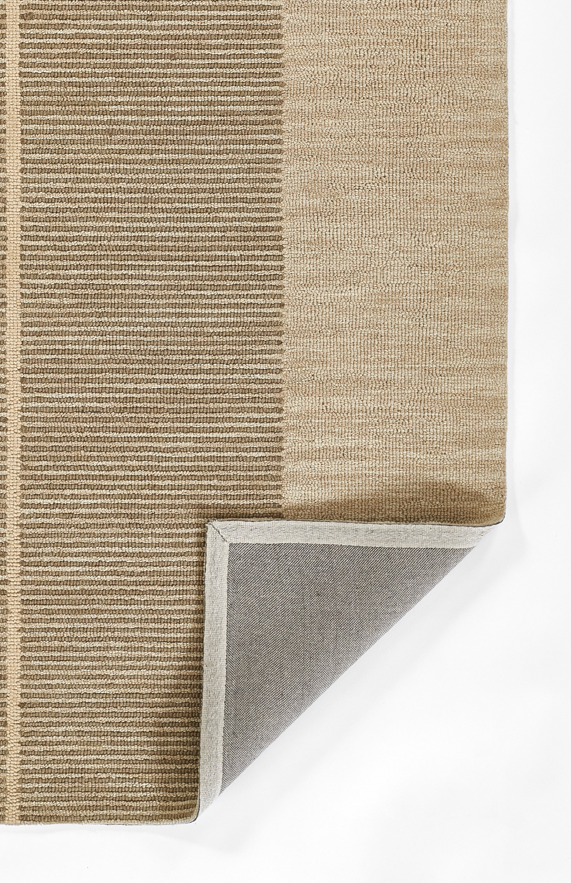 Beige-brown woven rug with horizontal striped left panel and plain right panel; corner folded to reveal gray underside.