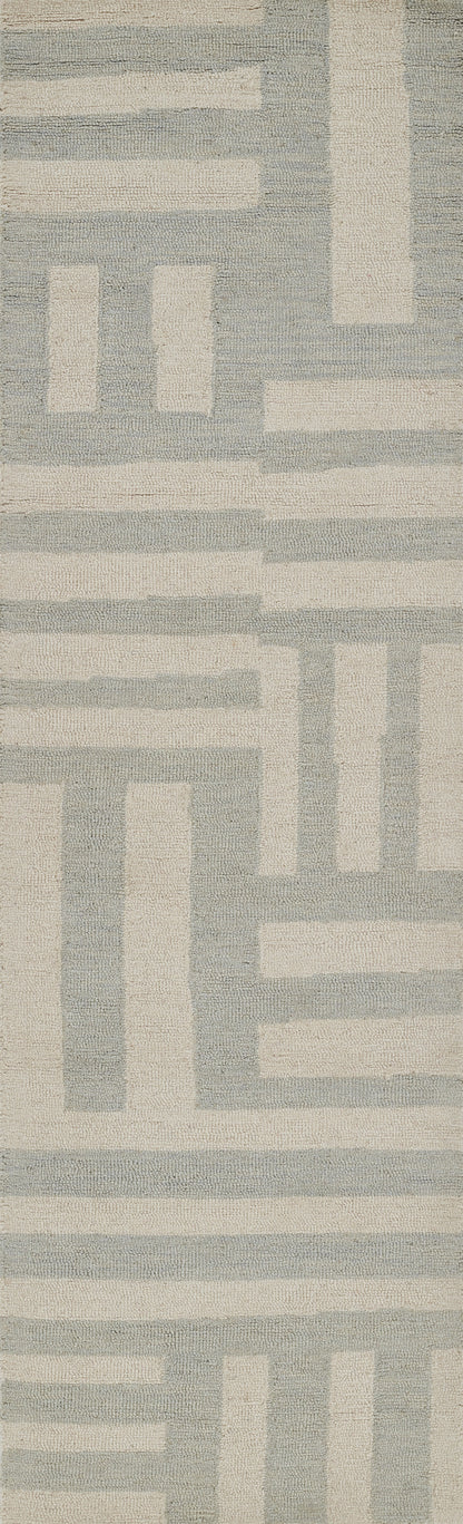 Long rectangular rug with a geometric maze pattern in soft blue and cream, featuring a textured woven surface.