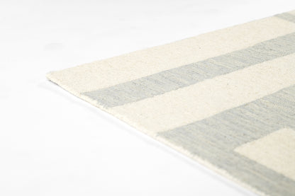 Cream and light blue striped woven area rug, rectangular with a subtle fringe edge.