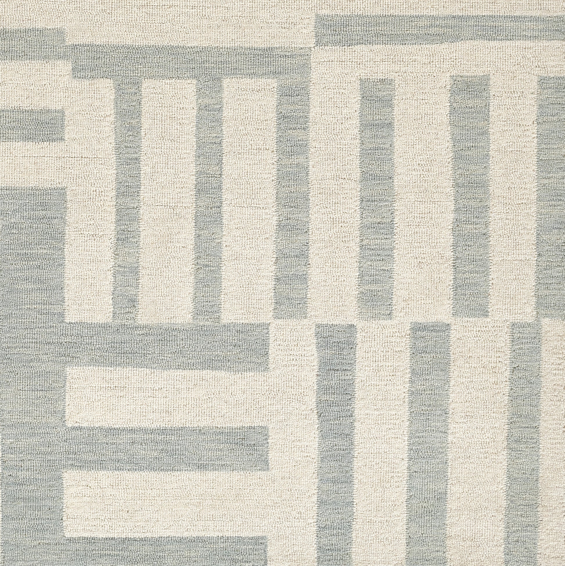Geometric runner in beige & blue-gray with interlocking rectangular motif and woven texture.