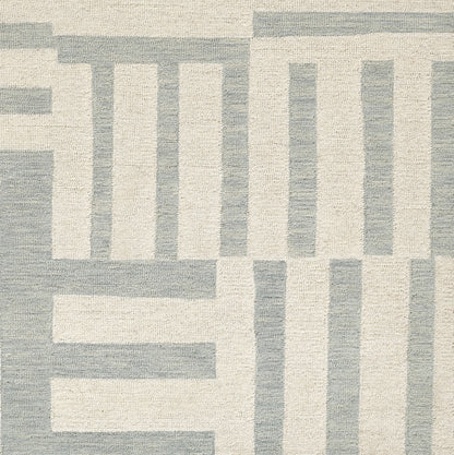 Textured area rug in cream and light blue-gray with bold geometric blocks in a modern, versatile design.