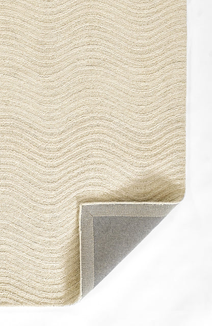 Beige woven rug with soft, wavy looped pile; folded corner reveals gray underside.