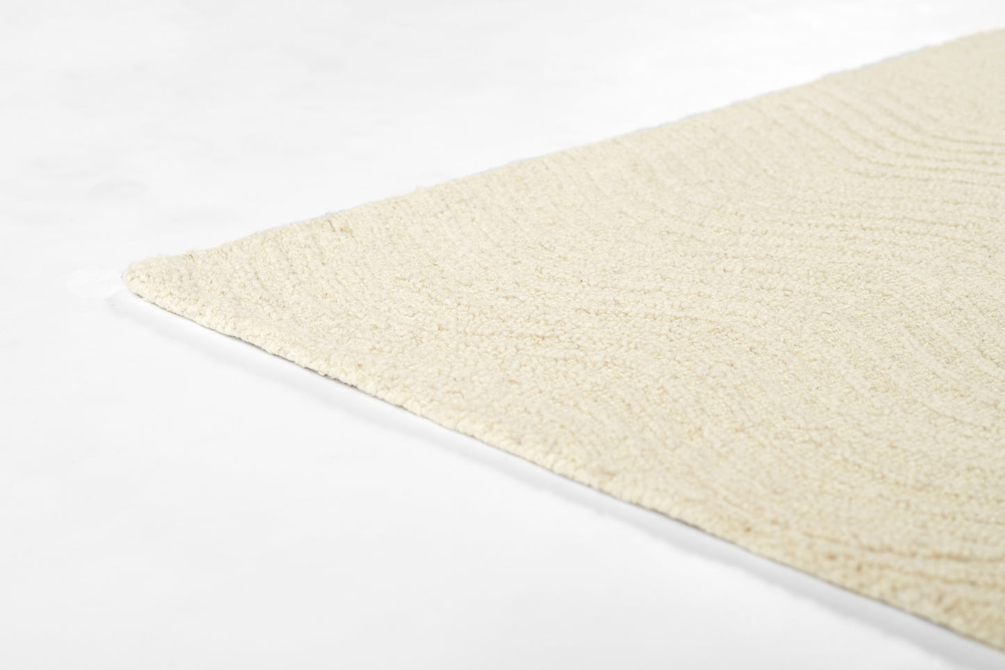 Cream textured area rug with soft loop pile, angled corner visible, ideal for modern living spaces.