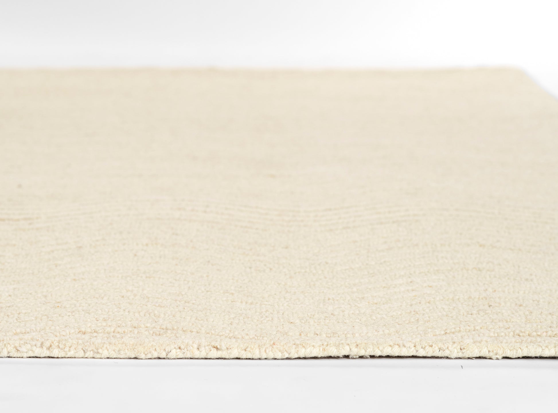 Ivory cream rectangular rug with soft plush pile; minimalist home decor, ideal for living room or bedroom.
