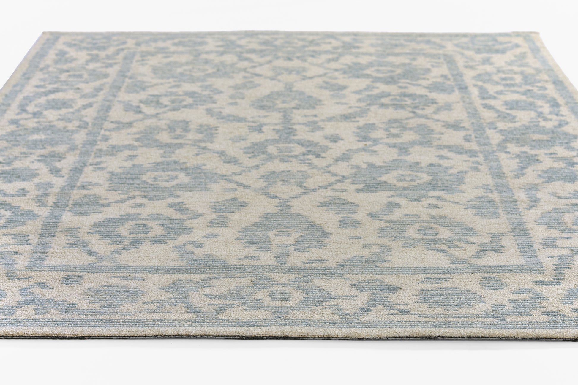 Rectangular blue and beige distressed damask area rug with decorative border and low-pile texture, 2' x 3'.