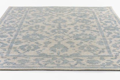 Rectangular blue and beige distressed damask area rug with decorative border and low-pile texture, 2' x 3'.