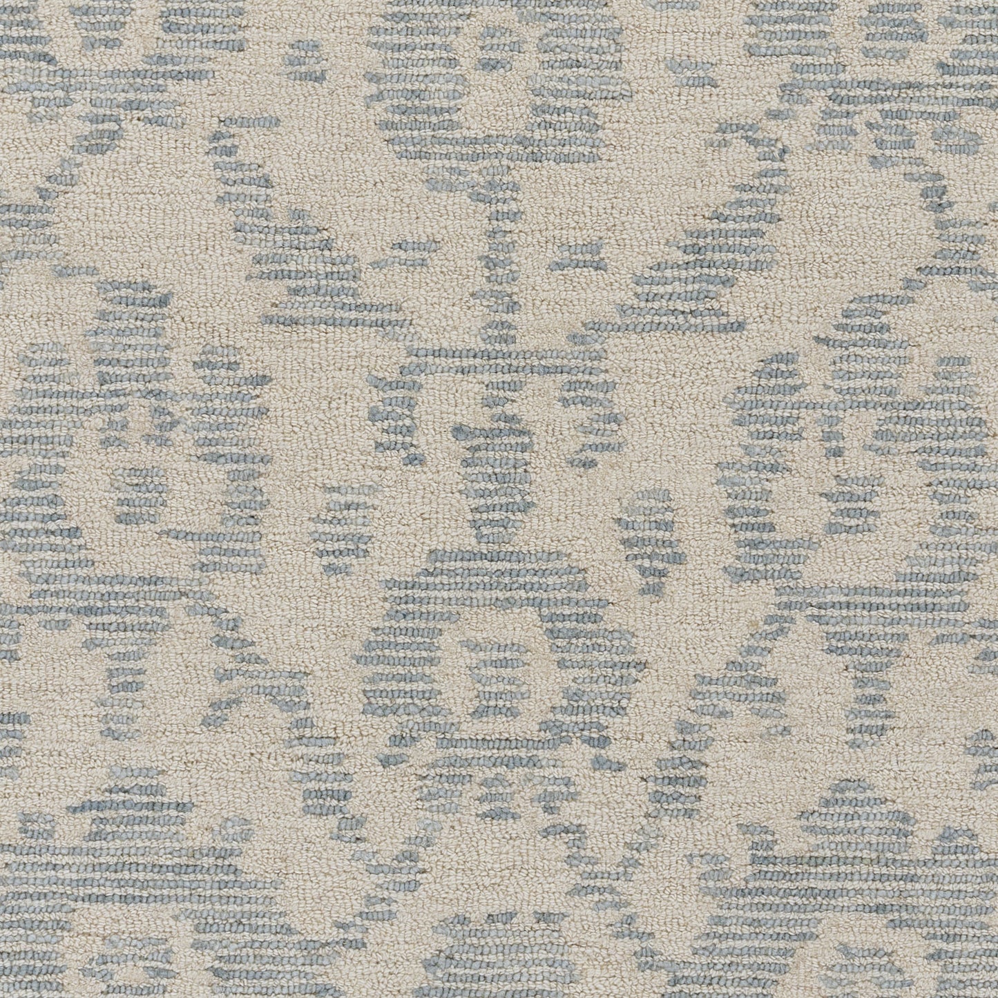 Beige rug with blue damask motif and woven texture.