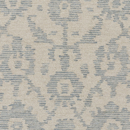 Beige rug with blue damask motif and woven texture.