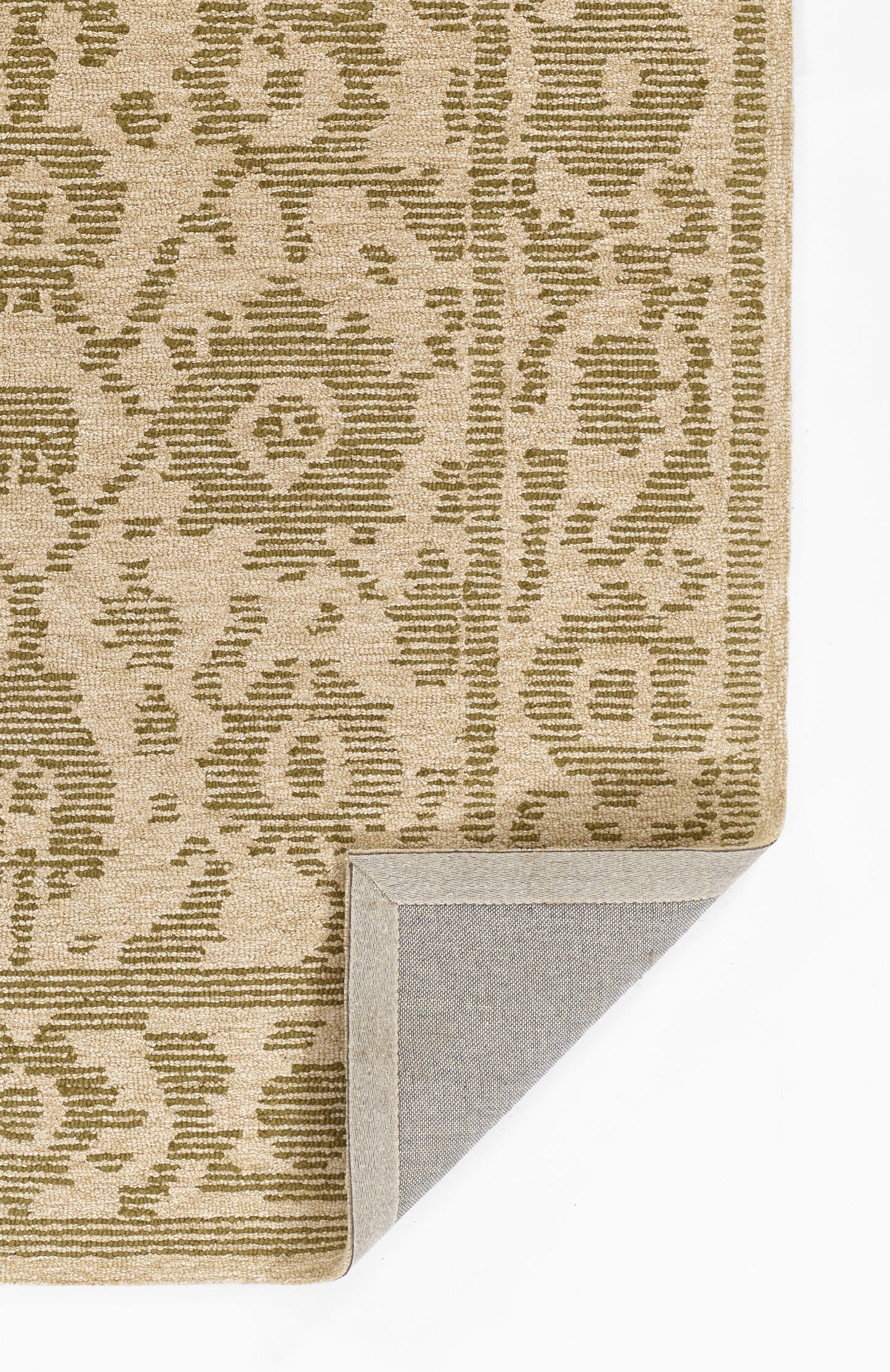 Beige woven area rug with olive geometric motifs, bound edge; folded corner reveals light gray backing.