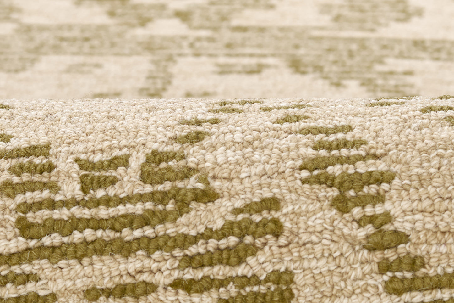 Beige textured rug with olive-green geometric pattern, woven pile, traditional oriental-inspired style.