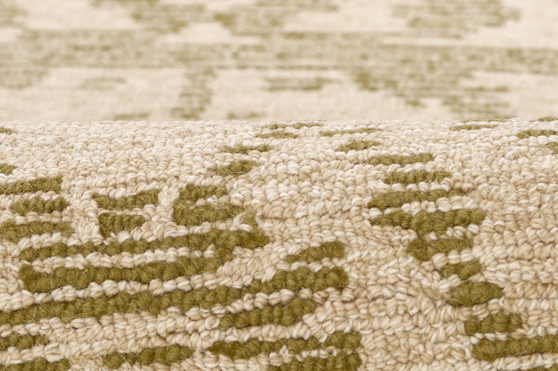 Beige textured rug with olive-green geometric pattern, woven pile, traditional oriental-inspired style.
