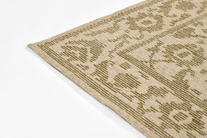 Beige rectangular area rug with olive-green geometric floral pattern; traditional, woven look.