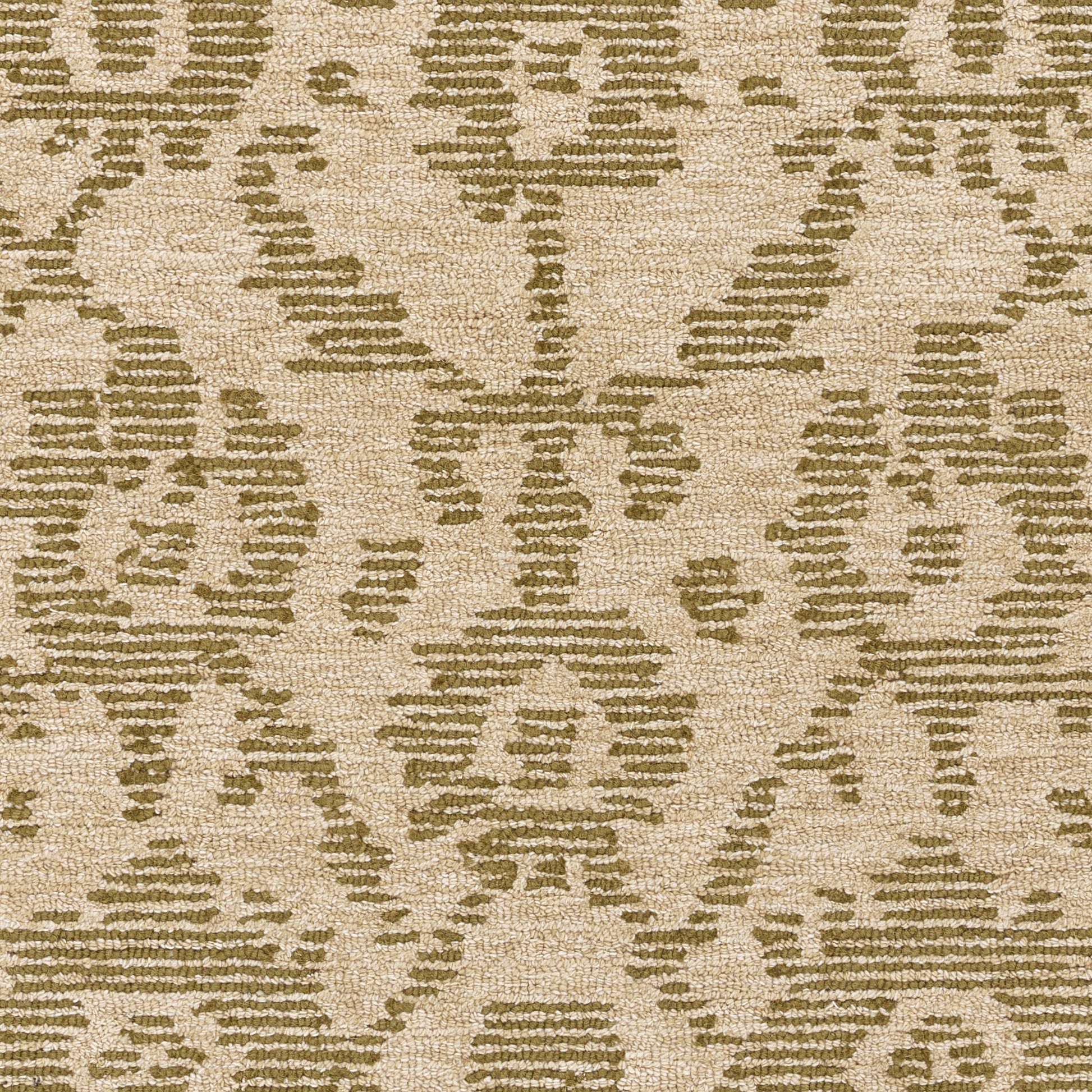 Beige area rug with sage-green geometric damask pattern and textured weave.