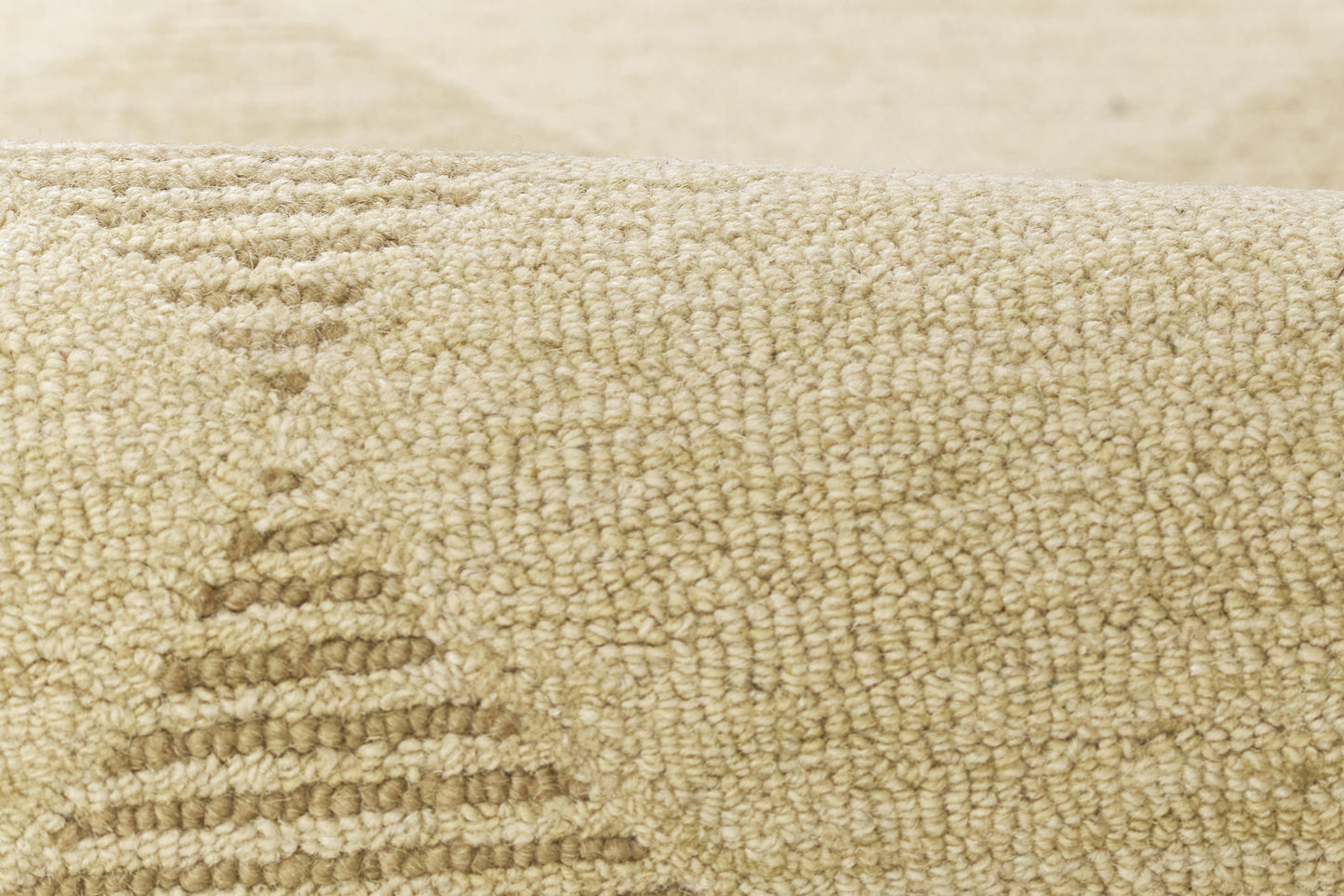 Beige loop-pile rug with subtle geometric pattern in cream tones, soft textured surface.