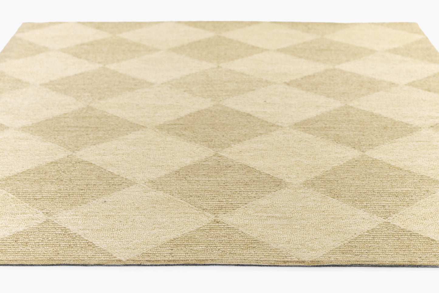 Beige woven rug with large cream & taupe diamond pattern; textured, rectangular floor decor.