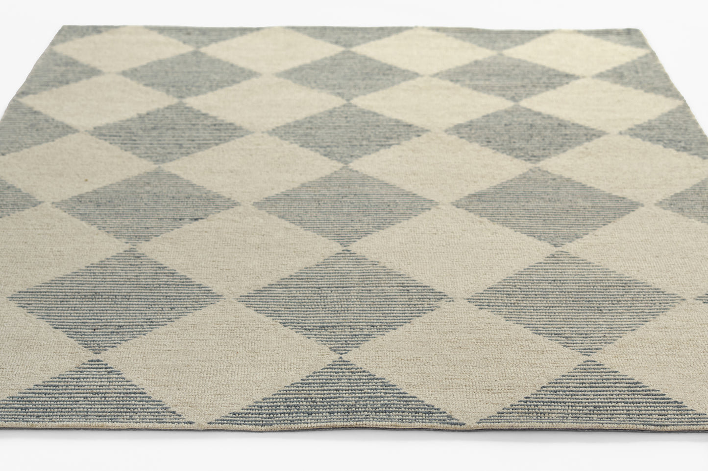 Blue and beige diamond-pattern woven area rug with geometric harlequin design.