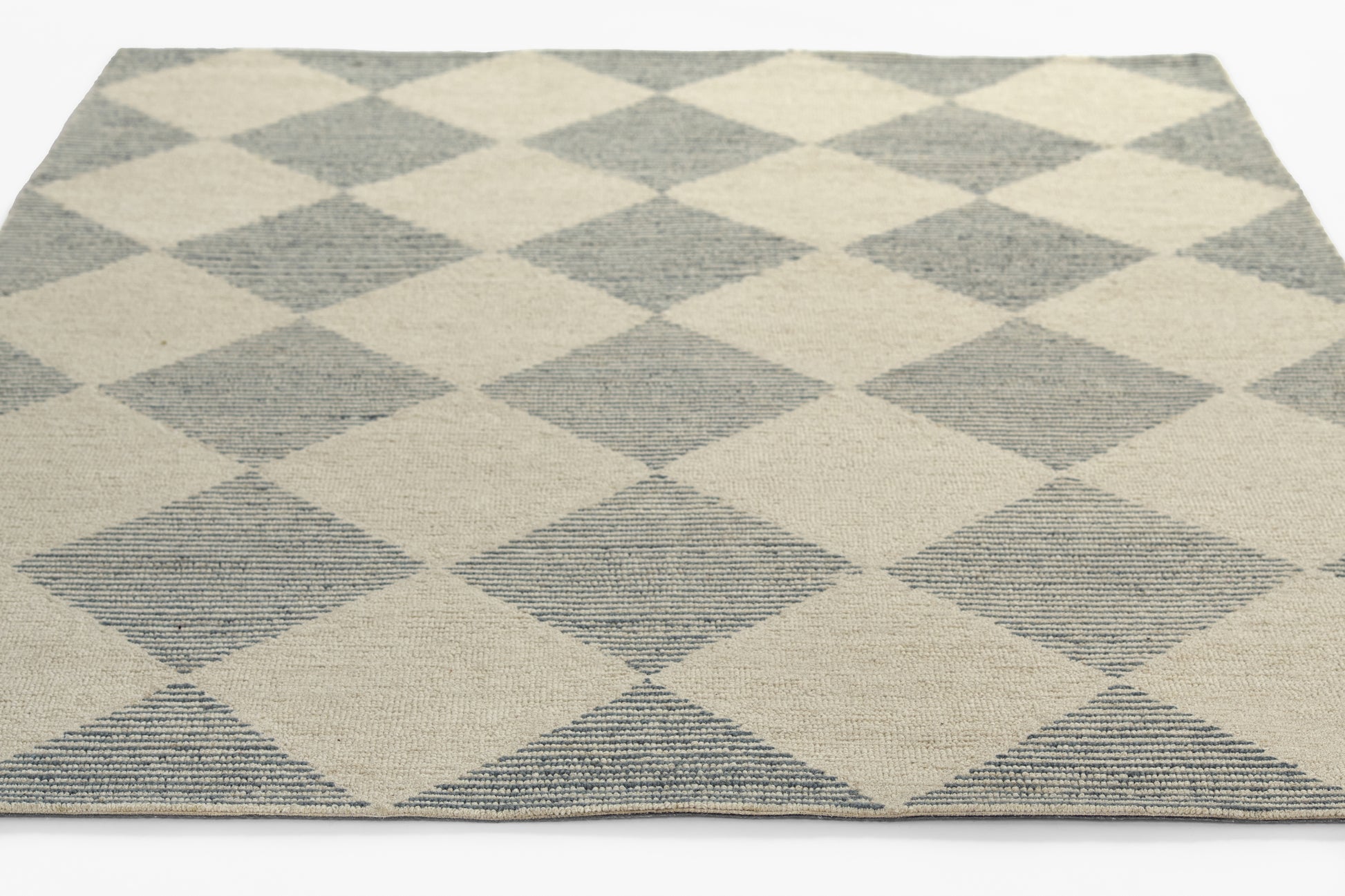 Blue and beige diamond-pattern woven area rug with geometric harlequin design.