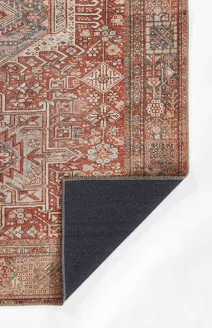 Red Persian-inspired rug with ivory geometric florals and ornate borders; folded corner shows dark navy backing.