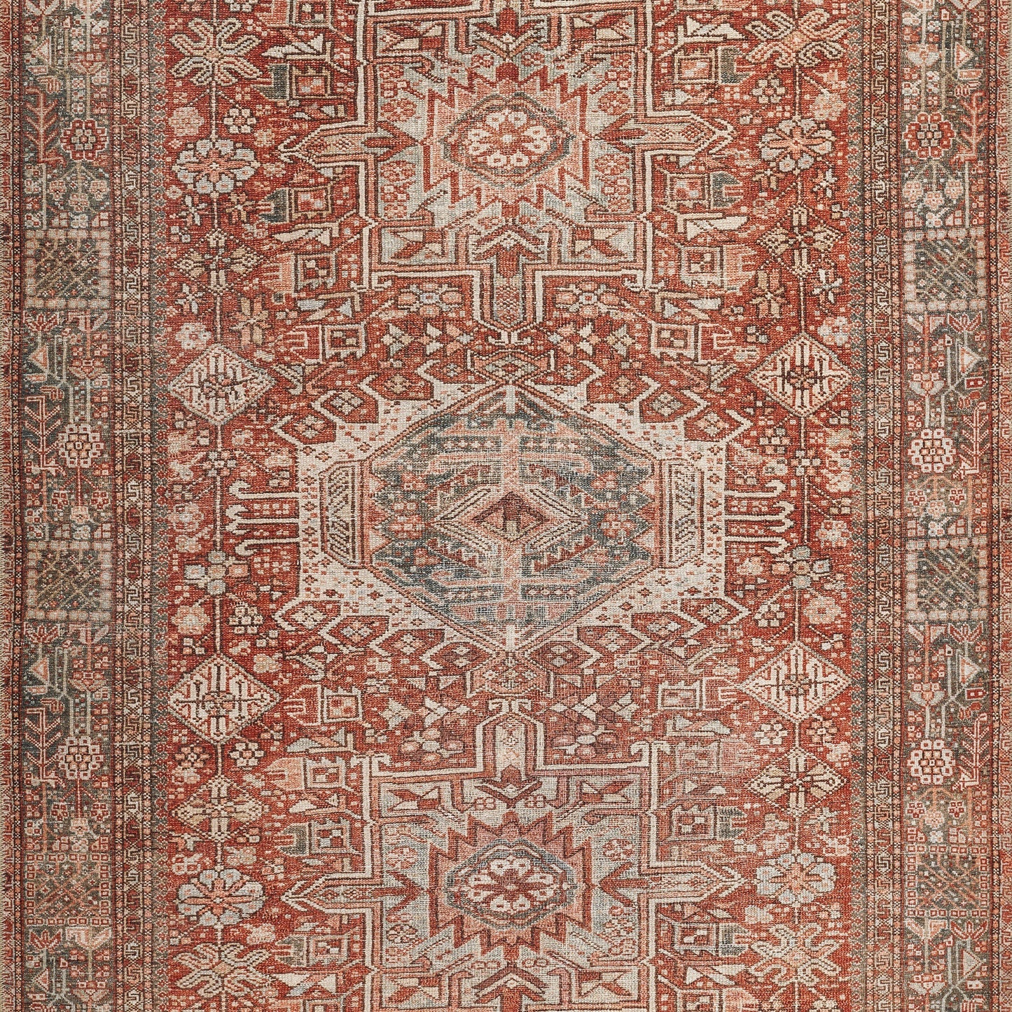 Red oriental rug with ivory geometric medallions, teal accents, and an ornate multi-border pattern.
