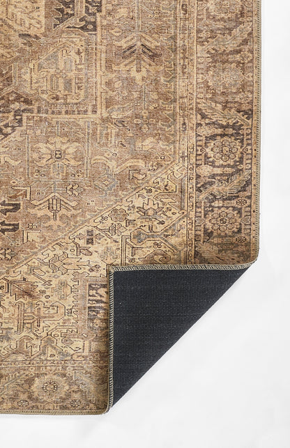 Beige-brown distressed oriental rug with intricate floral motifs and borders; corner folded to show dark navy backing.