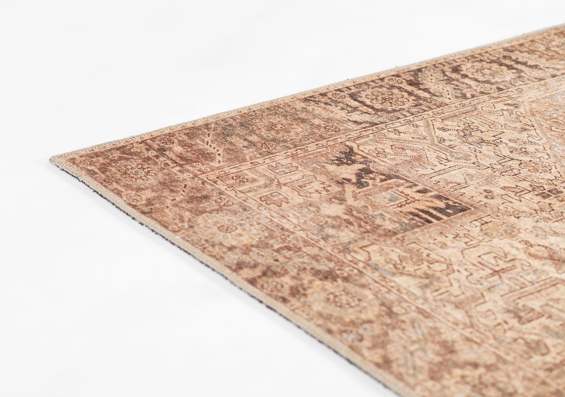 Brown vintage-style oriental rug with geometric motifs and distressed patina; low-pile area rug.