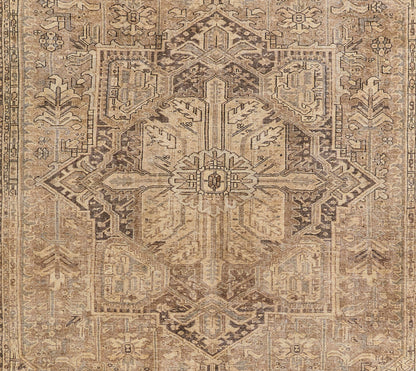 Rectangular vintage oriental rug in warm browns and beiges with a central medallion and intricate border.