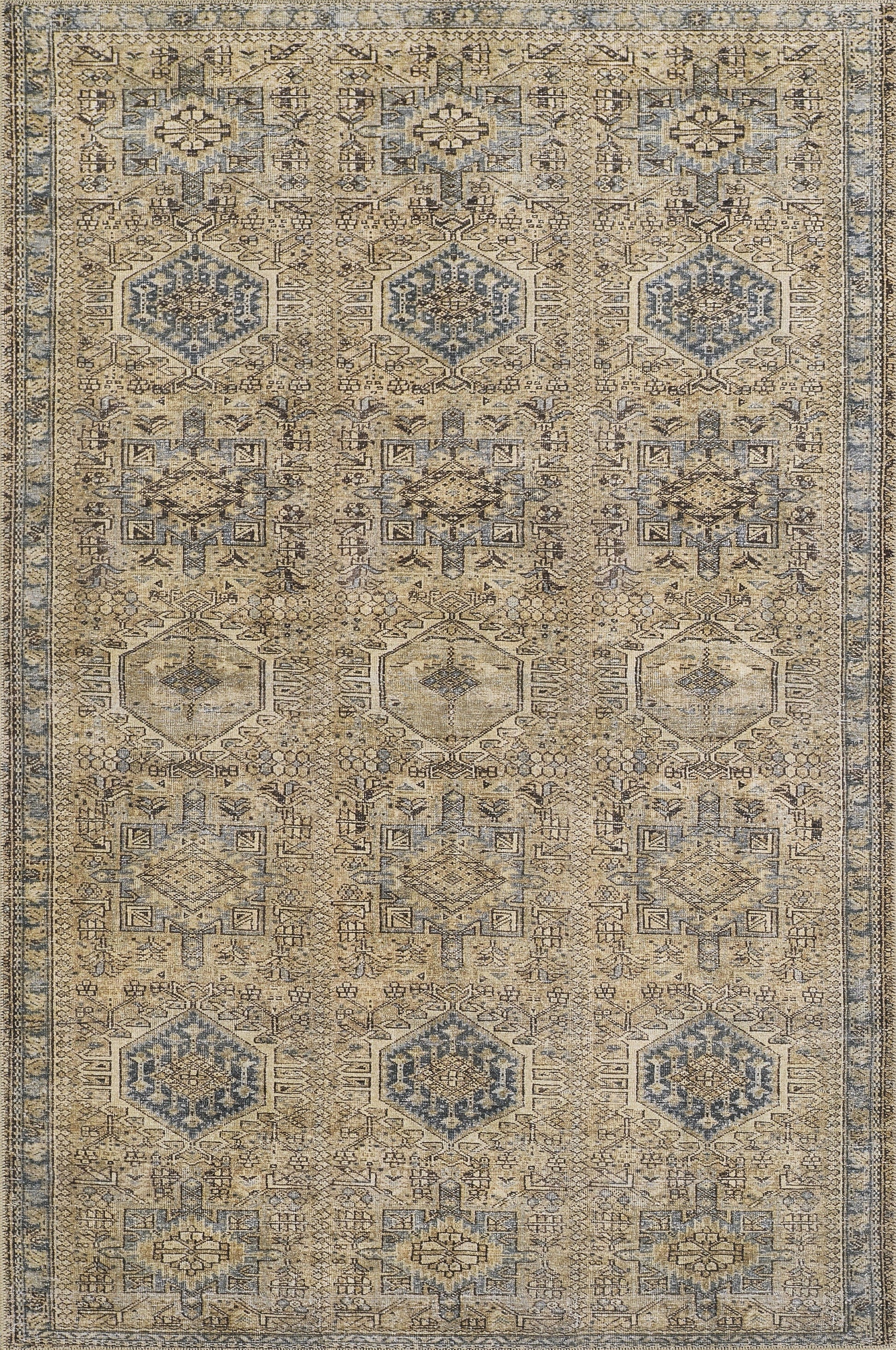 Beige and blue vintage-style oriental rug with repeating hexagonal medallions and intricate geometric borders.