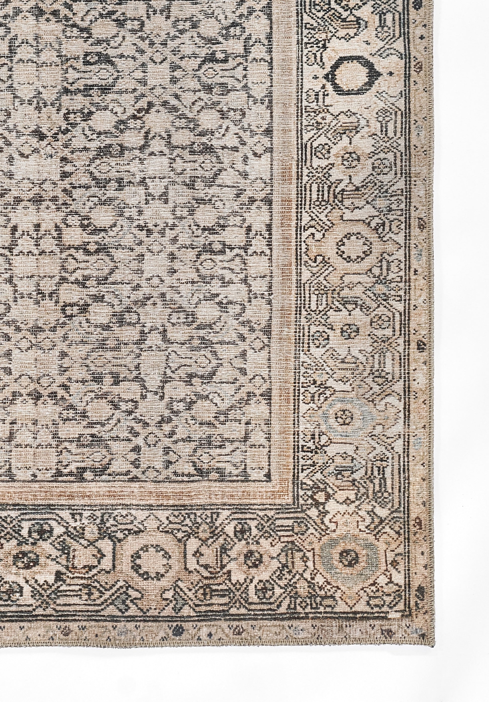 Beige distressed oriental rug corner with blue gray border and dense floral arabesque pattern.