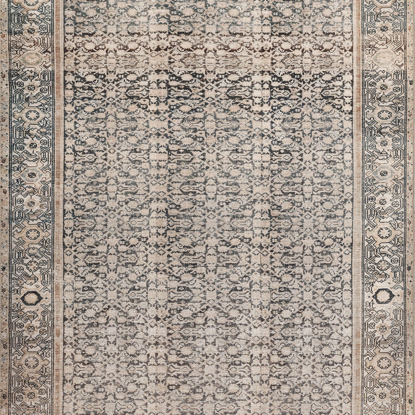 Beige distressed oriental rug with blue-grey floral motif and ornate border; Persian-style indoor area rug.