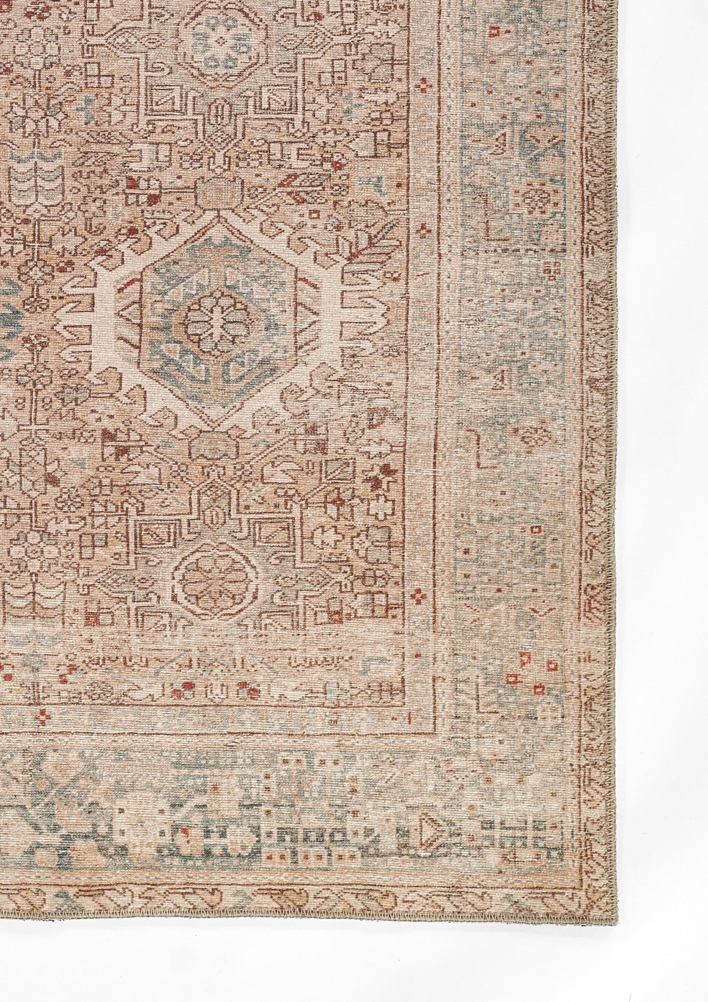 Beige oriental rug fragment with pale blue hexagonal medallion, rust accents and ornate border.
