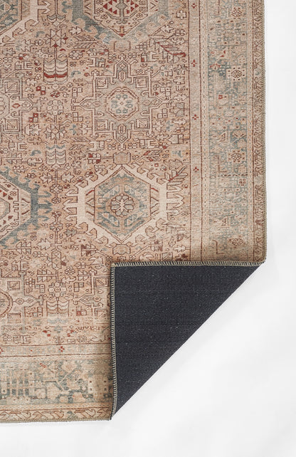 Oriental beige rug with blue and rust geometric medallions and detailed border; dark navy reverse corner folded.