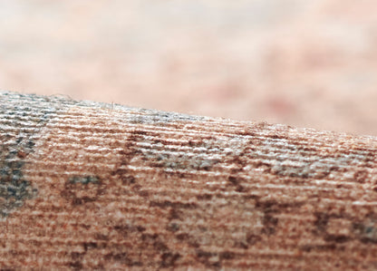 Close-up of a brown, textured surface with tan and gray speckles; rugged natural stone/bark-like pattern.