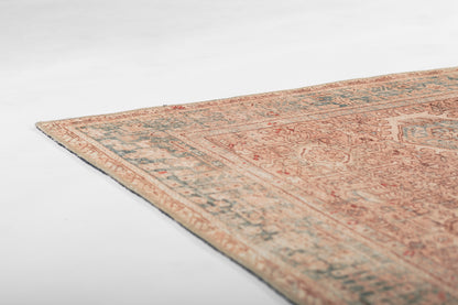 Rectangular vintage Persian-style wool rug in peach & beige tones with blue border and intricate medallion motifs.