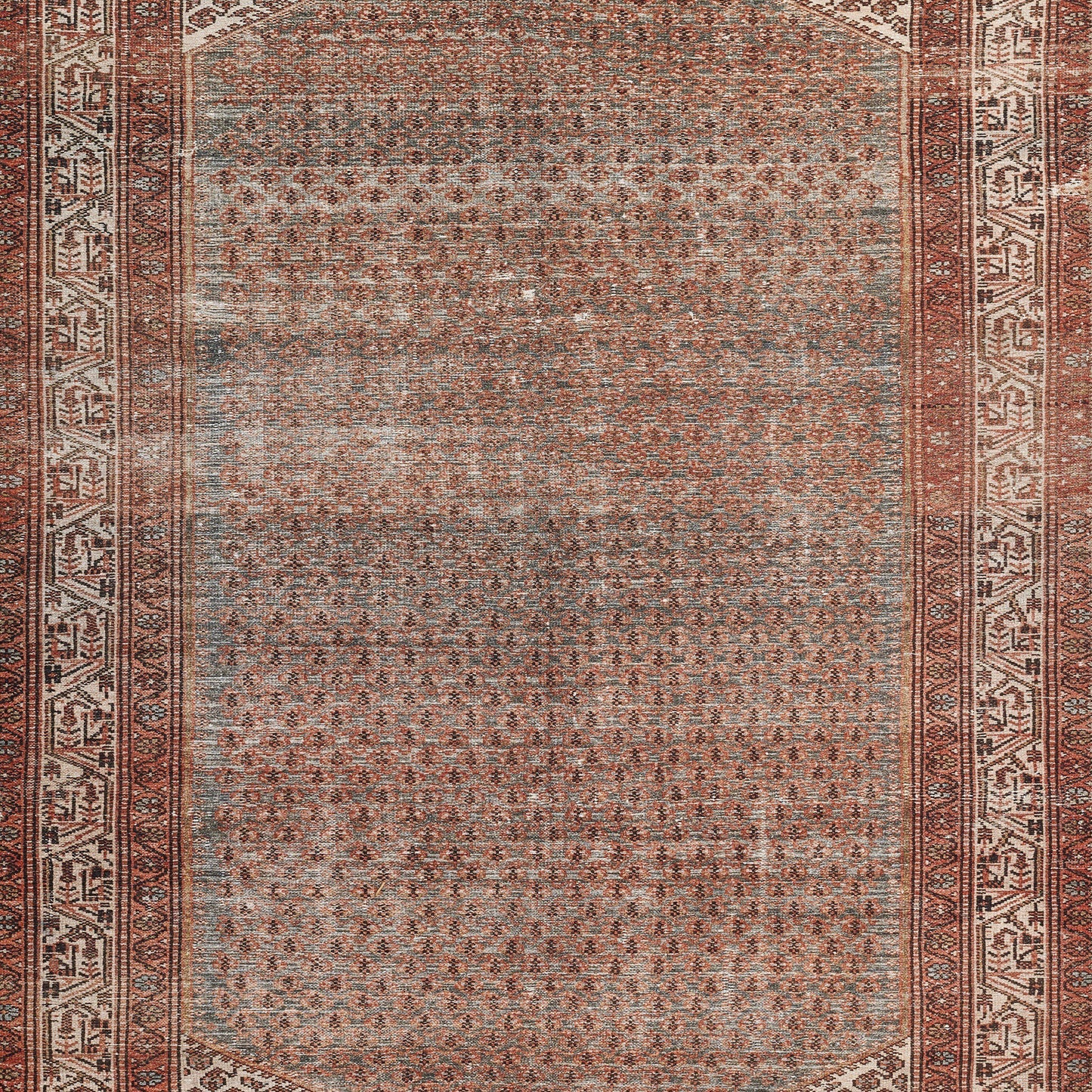Rectangular Persian-style area rug in rust, cream and gray with a dense central field and ornate geometric border.