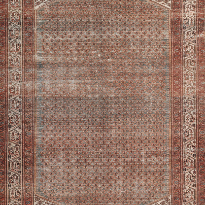 Rectangular Persian-style area rug in rust, cream and gray with a dense central field and ornate geometric border.