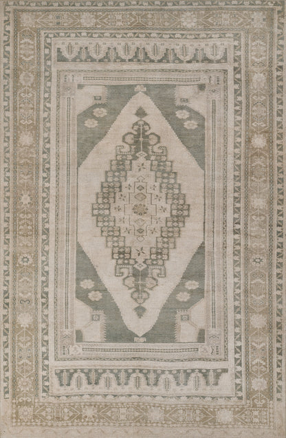 Sage green & beige oriental rug with a central diamond medallion and muted geometric border.