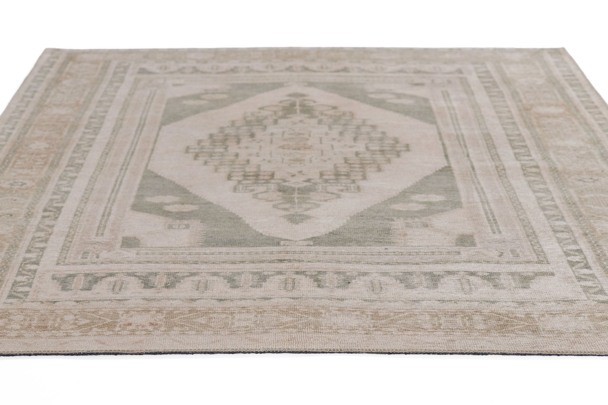 2' x 8' runner rug in neutral beige and sage green with a kilim-style diamond medallion and geometric borders.