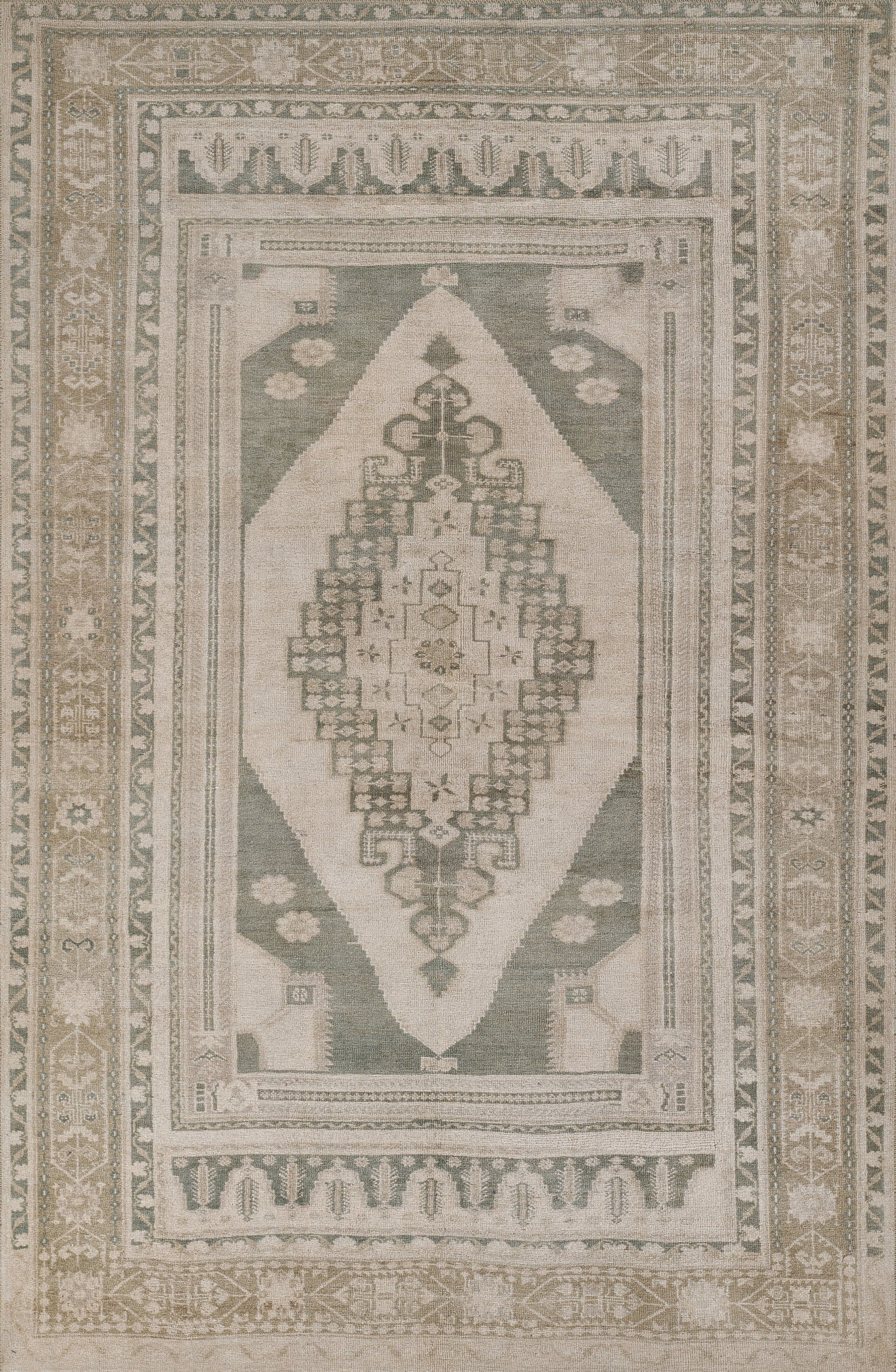 Green and beige oriental rug with central diamond medallion, intricate geometric motifs and bordered edges.
