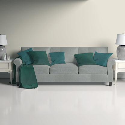 Petrol solid upholstery fabric shown in a lifestyle image; plain blue-green fabric.