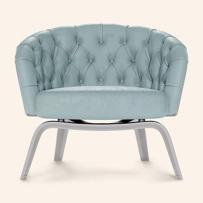Light blue velvet round tufted lounge chair with curved arms and silver metal pedestal legs.