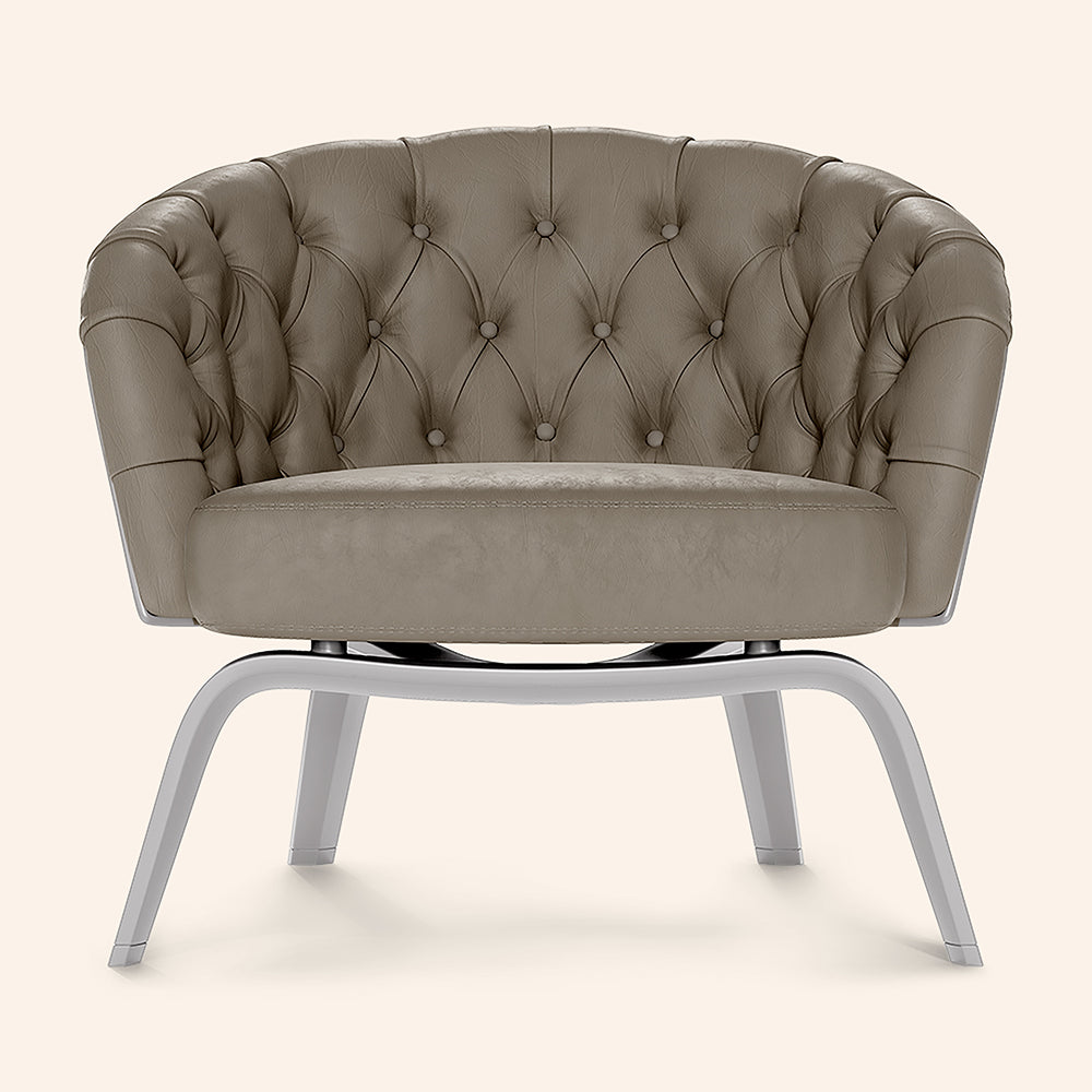 Taupe fabric accent chair with a buttoned back and curved arms on gray metal curved legs.