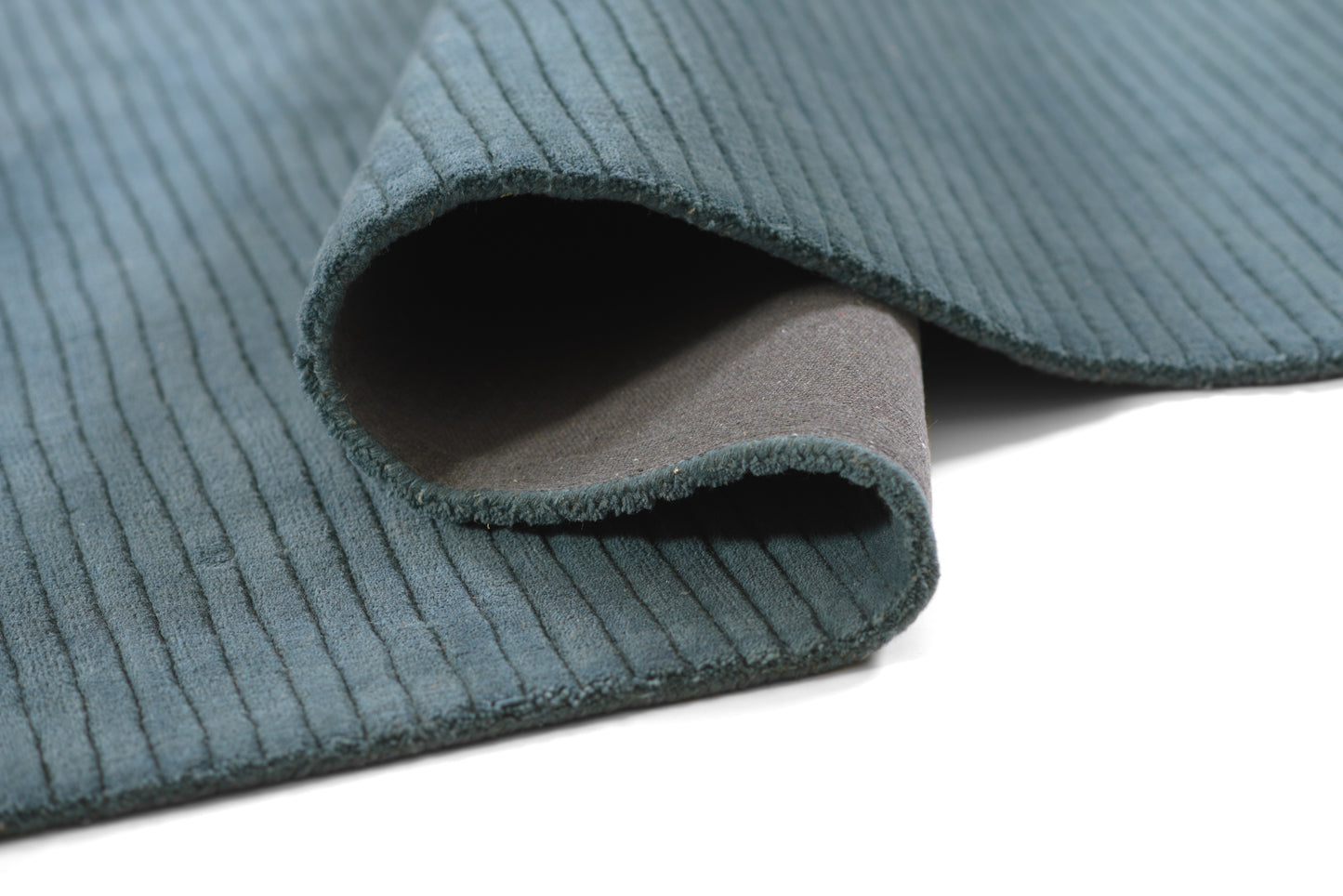 Teal corduroy fabric swatch with a rolled edge, ribbed wale texture and soft backing—great for upholstery or crafts.