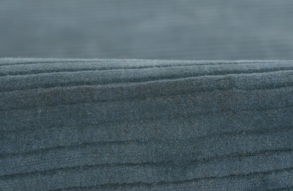 Dark blue fleece fabric close-up with soft, fuzzy texture and layered folds.