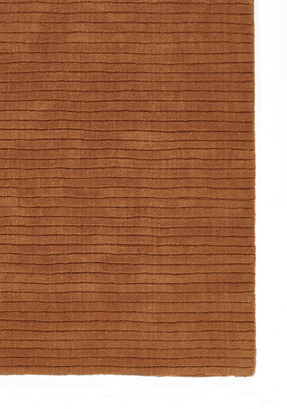 Terracotta brown corduroy-like rug with horizontal ridges, rectangular soft textile for living room or hall.