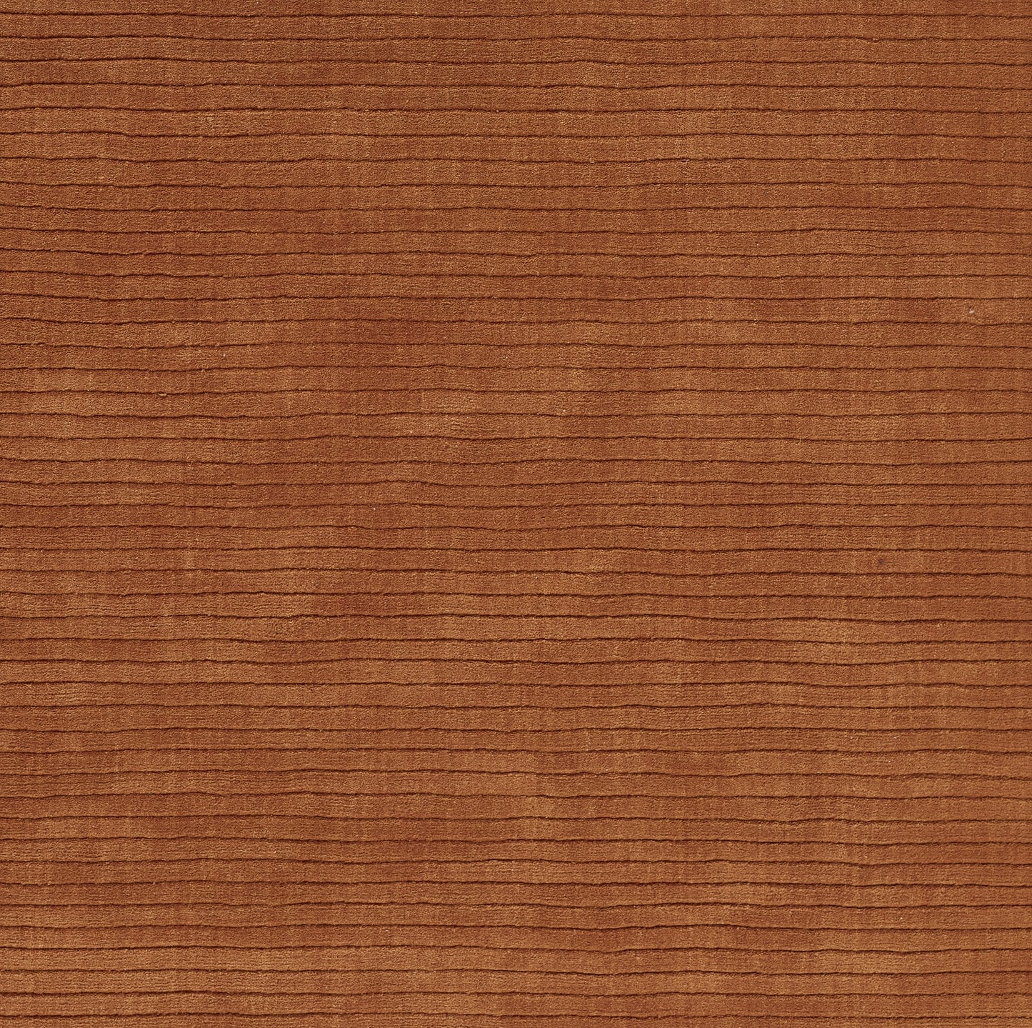 Rust brown corduroy fabric close-up with horizontal rib texture.