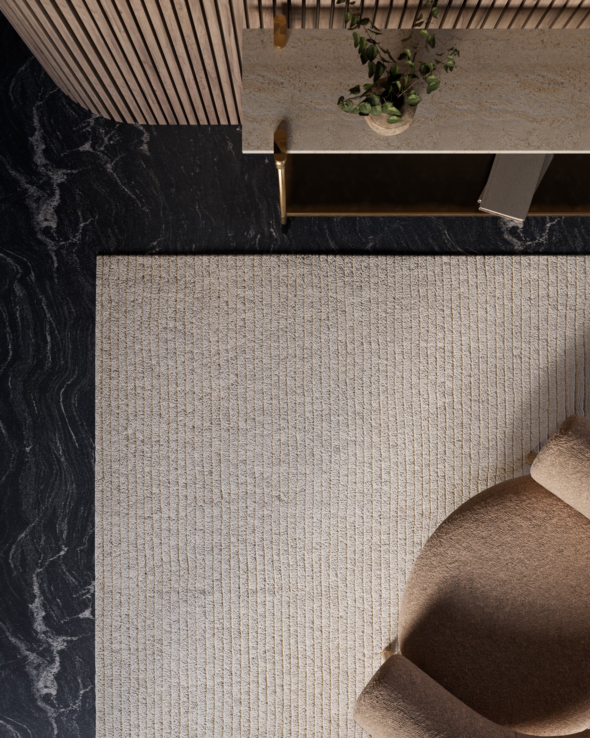Overhead view: beige ribbed rug on dark marble floor, taupe curved chair, and marble-topped console with gold legs and plant.